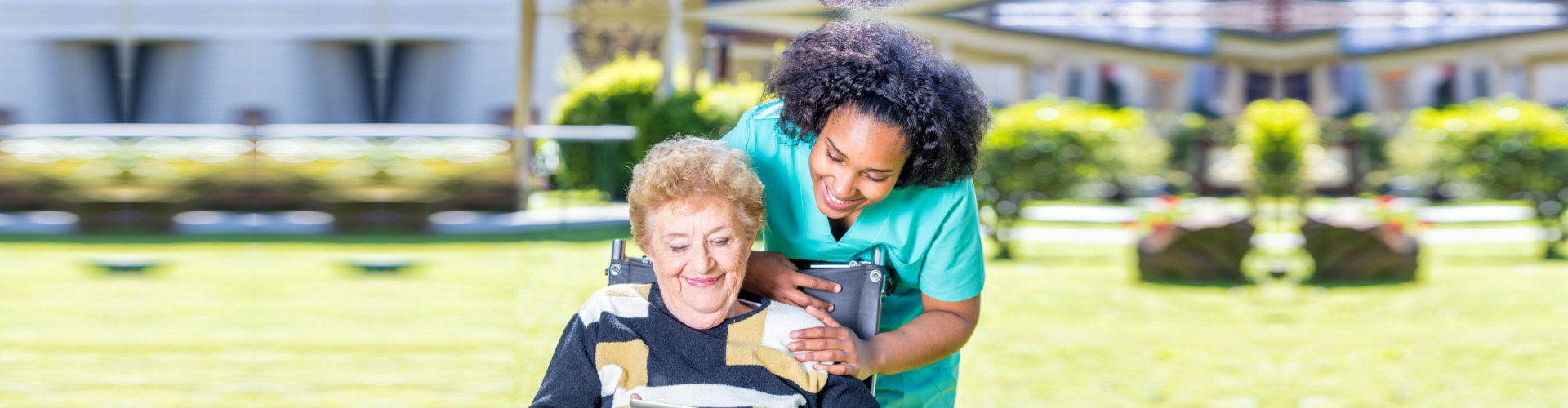 senior lady laughing with her caregiver