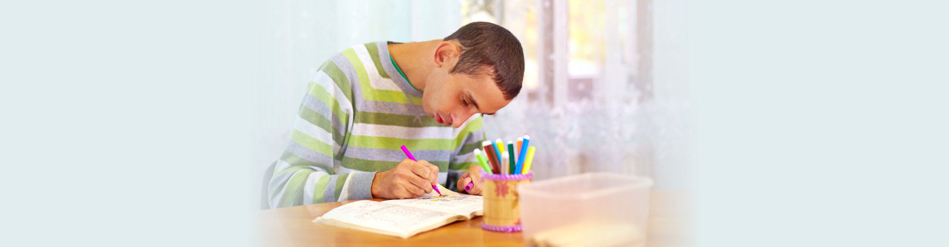 young adult man engages in self study, in rehabilitation center